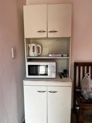 a microwave sitting on top of a white cabinet at Casa La Paz in Villa Carlos Paz