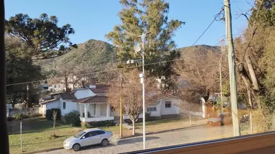 a car is parked in front of a house at Departamento España in Santa Rosa de Calamuchita