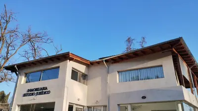 a building with the american food hotel sign on it at Departamento España in Santa Rosa de Calamuchita