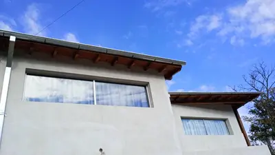 a white house with a sky in the background at Departamento España in Santa Rosa de Calamuchita