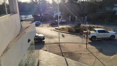 a white truck parked in a parking lot next to a street at Departamento España in Santa Rosa de Calamuchita