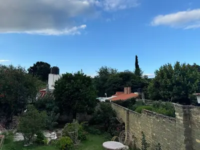 a view of a wall and trees and a silo at Chalet BERNI in Villa Carlos Paz