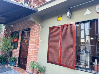 a house with wooden shutters on the side of it at Chalet BERNI in Villa Carlos Paz