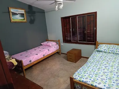 a bedroom with two beds and a window at Chalet BERNI in Villa Carlos Paz