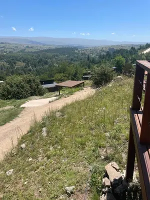 a view from the top of a hill with a dirt road at Medio Cielo Cabaña de Montaña in Rincón de Luna