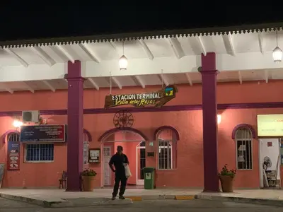 a man standing in front of a building at night at Refugios del Alma 24 in Villa de Las Rosas
