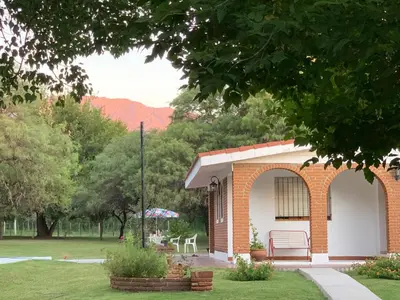 a brick building with a bench in a park at Refugios del Alma 24 in Villa de Las Rosas