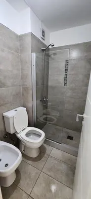 a bathroom with a toilet and a shower at Dpto zona GRAL PAZ a cuadras de la Clínica Reina Fabiola in Cordoba