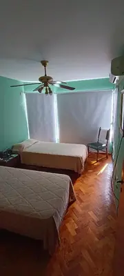 a bedroom with two beds and a ceiling fan at Departamento 1D Centro in Cordoba