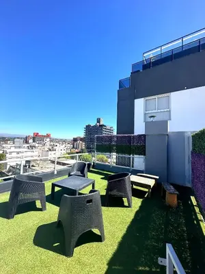 a patio with chairs and tables on top of a building at Depto Elegante, Centrico, Calef Central, Cochera in Villa Carlos Paz