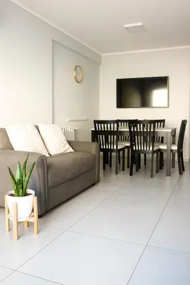 a living room with a couch and a table and chairs at Depto Elegante, Centrico, Calef Central, Cochera in Villa Carlos Paz