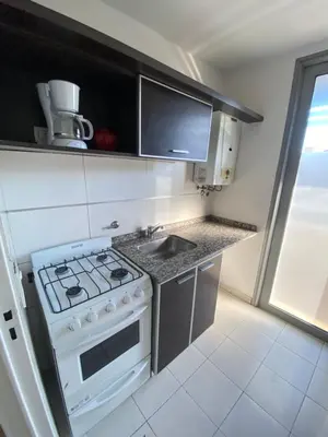 a kitchen with a white stove and a sink at LitStay Montevideo in Cordoba