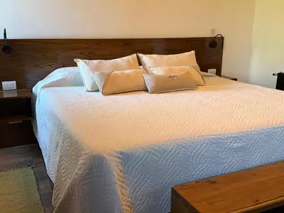 a large bed with two pillows on top of it at Altos de Cumbrecita - Casa Suite in La Cumbrecita