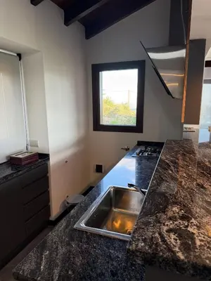 a kitchen with a sink and a counter top at Altos de Cumbrecita - Casa Suite in La Cumbrecita