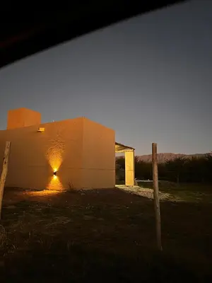 a building with a light on the side of it at Casa Las Breas del Champaquí in Las Tapias