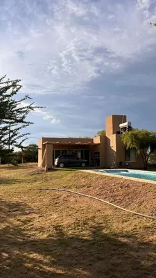 a house with a car parked in front of it at Casa Las Breas del Champaquí in Las Tapias