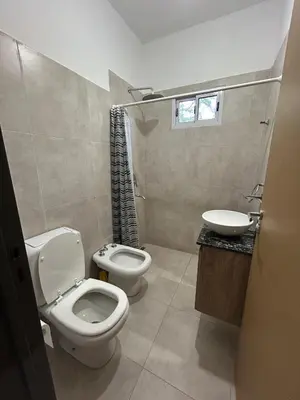 a bathroom with a toilet and a sink at Casa Las Breas del Champaquí in Las Tapias