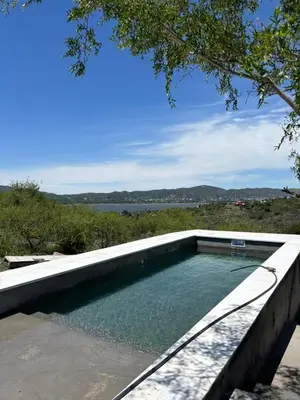 a swimming pool with a view of the water at El Descanso in San Roque