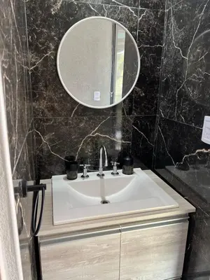 a bathroom with a sink and a mirror at El Descanso in San Roque