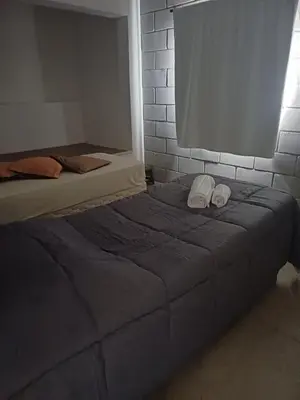 a bed with two white shoes on top of it at El Descanso in San Roque