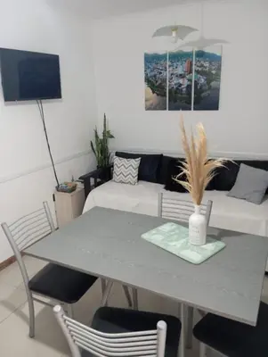 a table and chairs in a living room with a couch at Dpto 1 dormitorio céntrico piscina cochera in Villa Carlos Paz