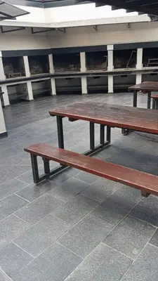 two wooden benches sitting next to each other at Dpto 1 dormitorio céntrico piscina cochera in Villa Carlos Paz
