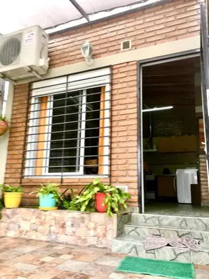 a house with a window and plants in front of it at ovidio and Elda's house in Villa Carlos Paz