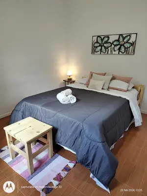a bedroom with a large bed with towels on it at El rincón in Merlo