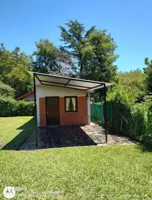 a small house with a garage in a yard at El rincón in Merlo