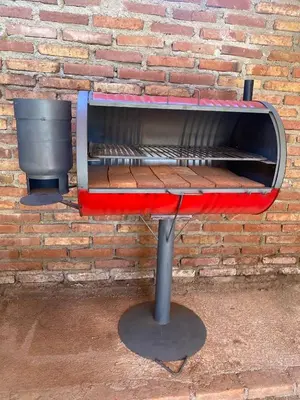 a barbecue grill in front of a brick wall at Ataias 2 in Santa Rosa de Calamuchita