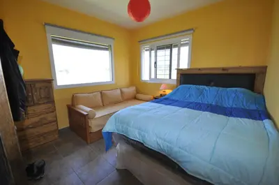 a bedroom with a bed and a couch at pequeño refugio in Potrero de Garay