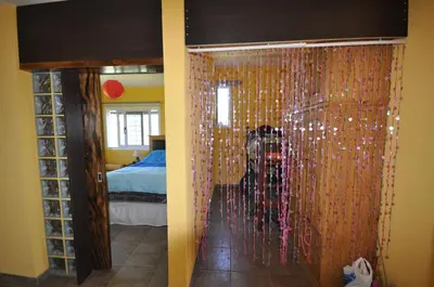 a person standing behind a glass door in a bedroom at pequeño refugio in Potrero de Garay