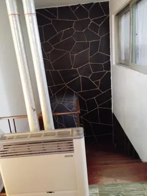 a staircase in a room with a tile wall at Departamentos Amanda in Santa Rosa de Calamuchita