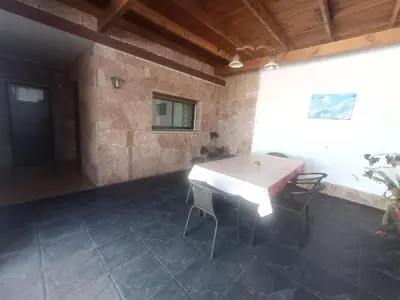 a patio with a table and chairs in a building at Departamentos Amanda in Santa Rosa de Calamuchita
