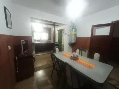 a dining room with a table and chairs in a room at Departamentos Amanda in Santa Rosa de Calamuchita