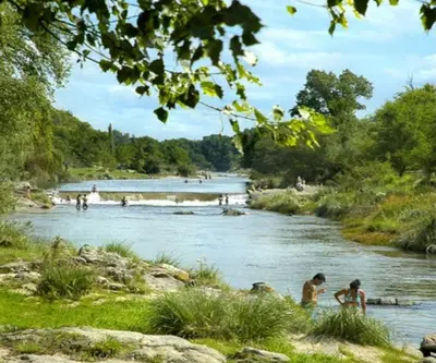a group of people playing in a river at La candelaria in Villa Ciudad Parque