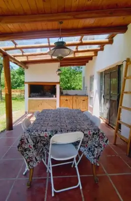 a patio with a table and chairs on it at La candelaria in Villa Ciudad Parque