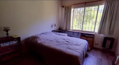 a bedroom with a bed and a window at La candelaria in Villa Ciudad Parque