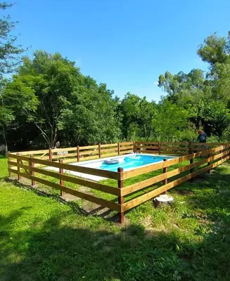 a wooden fence around a swimming pool in a yard at La candelaria in Villa Ciudad Parque