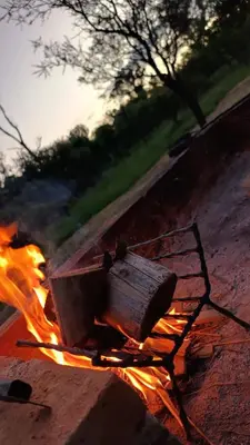 a fire with a wooden box on top of it at Cabaña el atardecer in Villa Anizacate