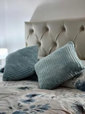 a bed with two pillows on top of it at NUEVEAGUAS - Apartamento Panorámico sobre el Lago in Villa Carlos Paz