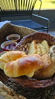 a basket of bread and pastries on a table at Cabañas del Campo - Solo Adultos in Atos Pampa