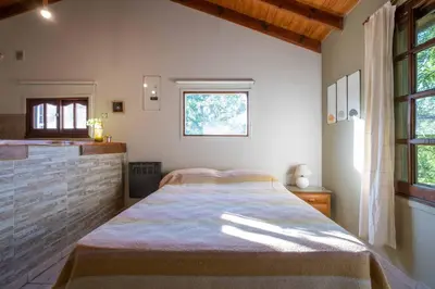 a bedroom with a bed and a window at Grace in Villa General Belgrano