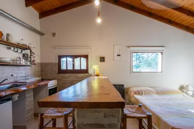 a kitchen with a large wooden island in a room at Grace in Villa General Belgrano