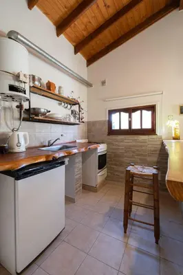 a kitchen with white appliances and a counter top at Grace in Villa General Belgrano