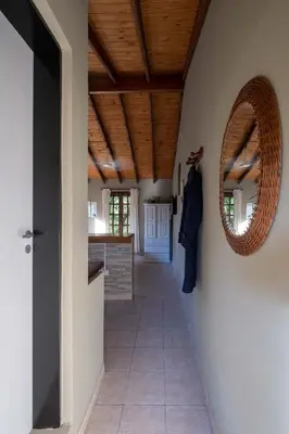 a hallway of a house with a mirror on the wall at Grace in Villa General Belgrano
