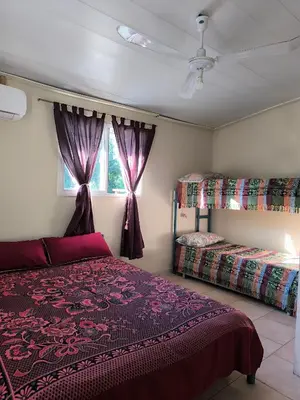 a bedroom with two beds and a window at El Maná in Villa Cura Brochero