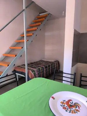 a room with a table with a plate on a table at El Maná in Villa Cura Brochero