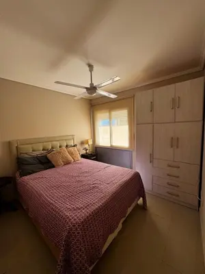 a bedroom with a bed and a ceiling fan at Alquiler Temporario Amoblado in Cordoba