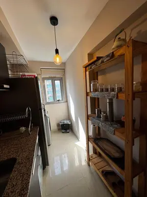 a kitchen with wooden shelves in a room at Alquiler Temporario Amoblado in Cordoba
